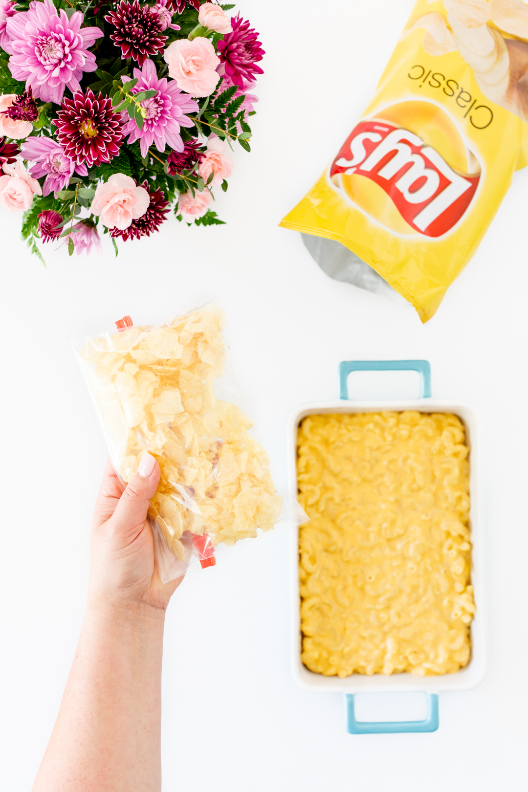 crushing potato chips in a plastic baggie