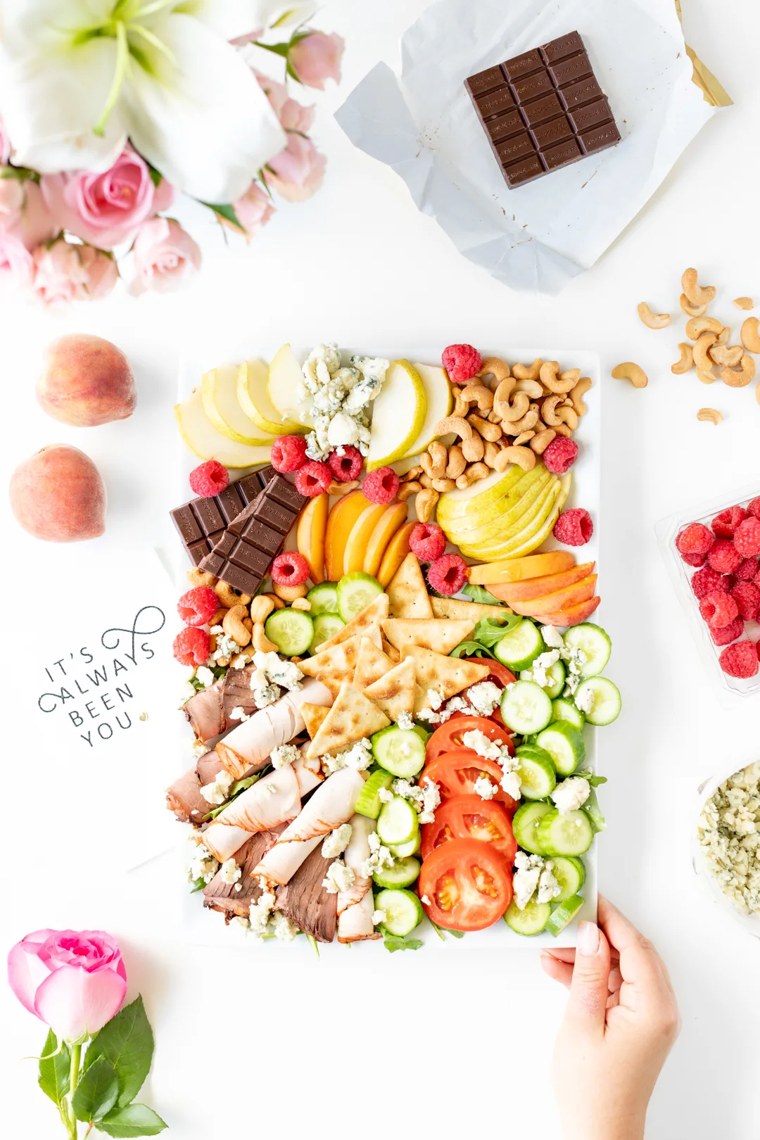 snack tray with fresh chopped vegetables, fruits, meats and cheeses.