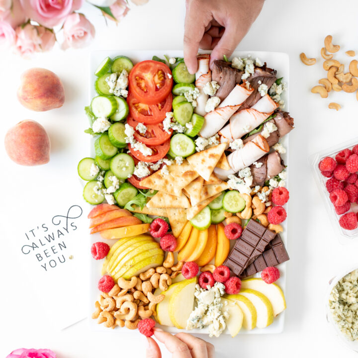 man and woman sharing snack board