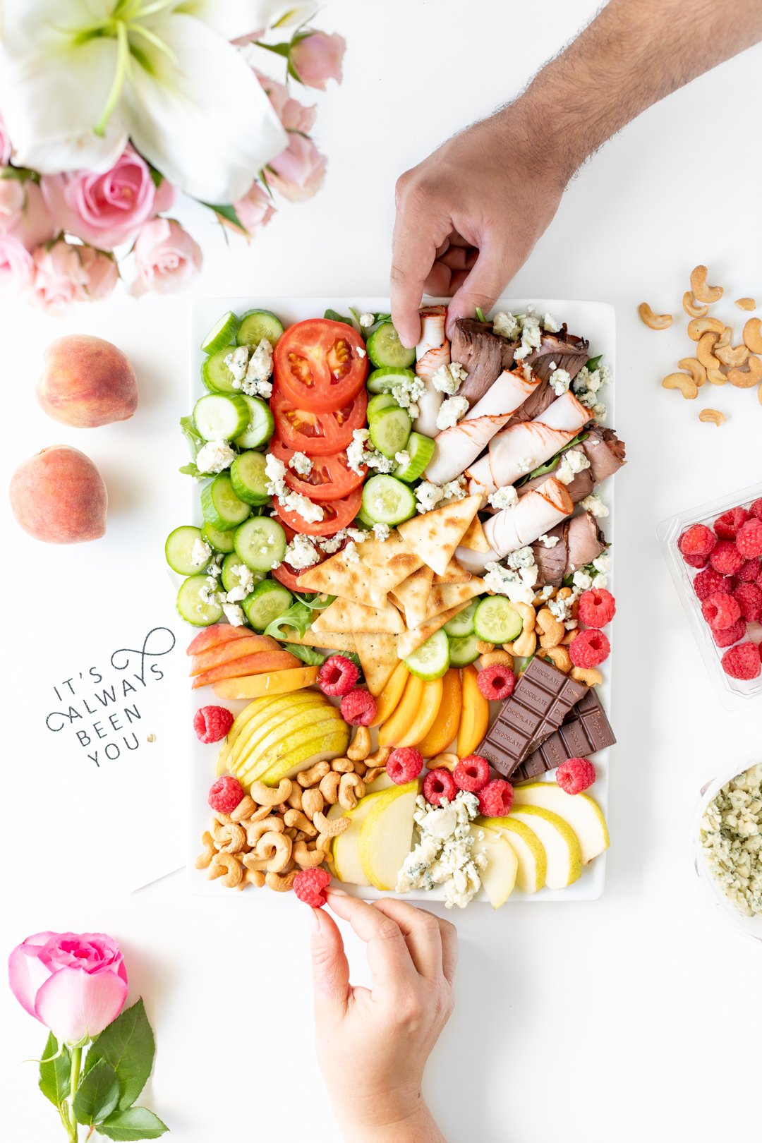 man and woman sharing snack board