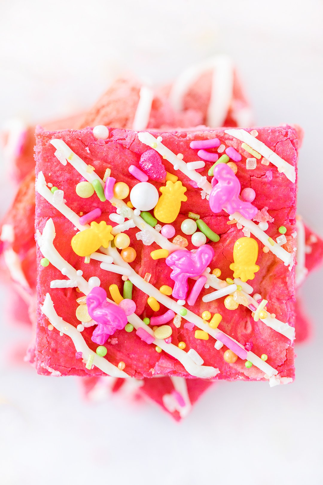 stack of pink blondie bars with flamingo sprinkles on top