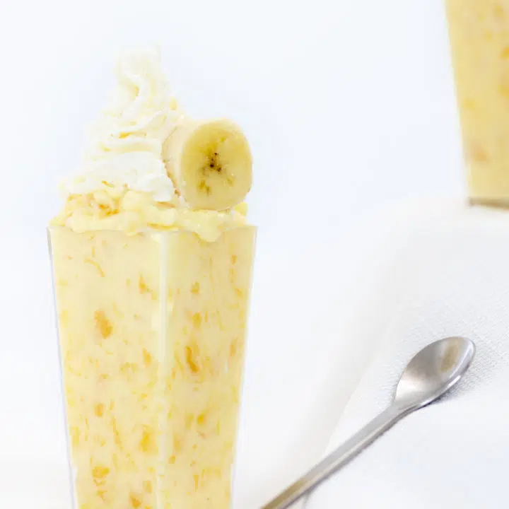 pineapple pudding topped with banana and whipped cream