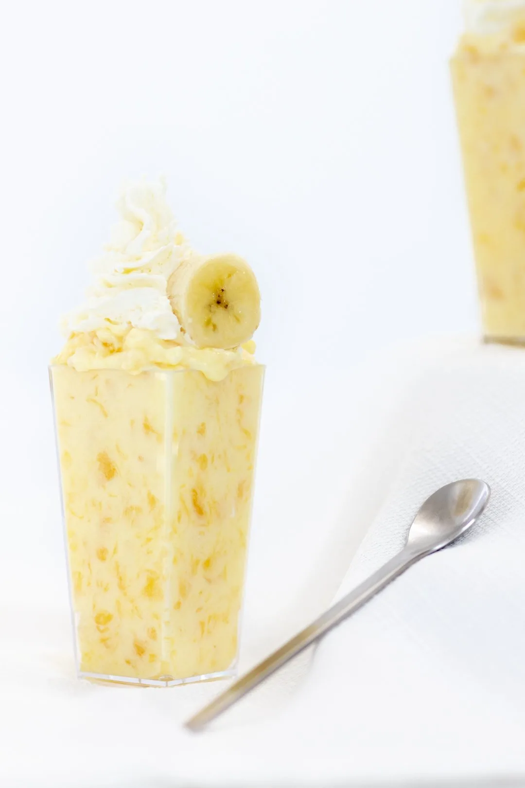 pineapple pudding topped with banana and whipped cream