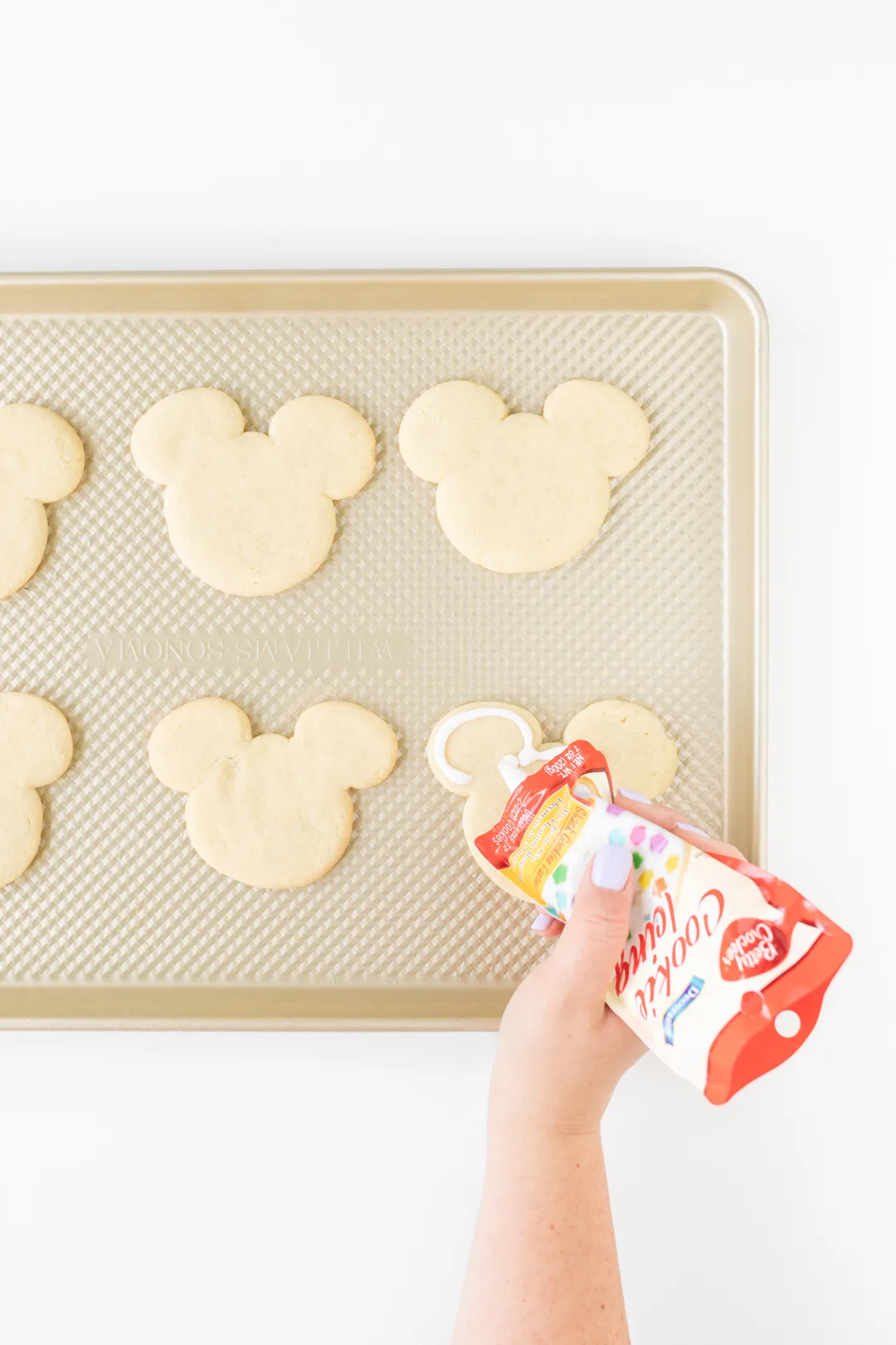 Adding icing to Mickey Mouse Cookies