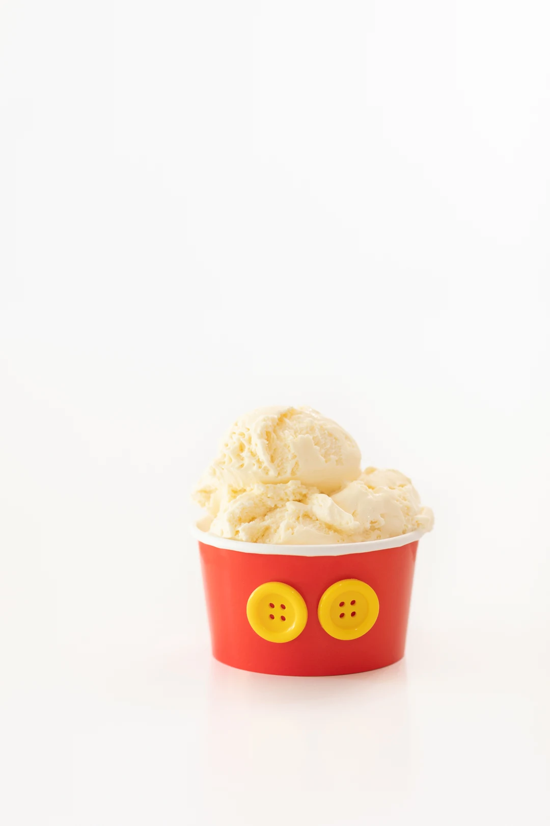 Mickey Mouse Cup with Yellow Buttons and Scoops of Vanilla Ice Cream