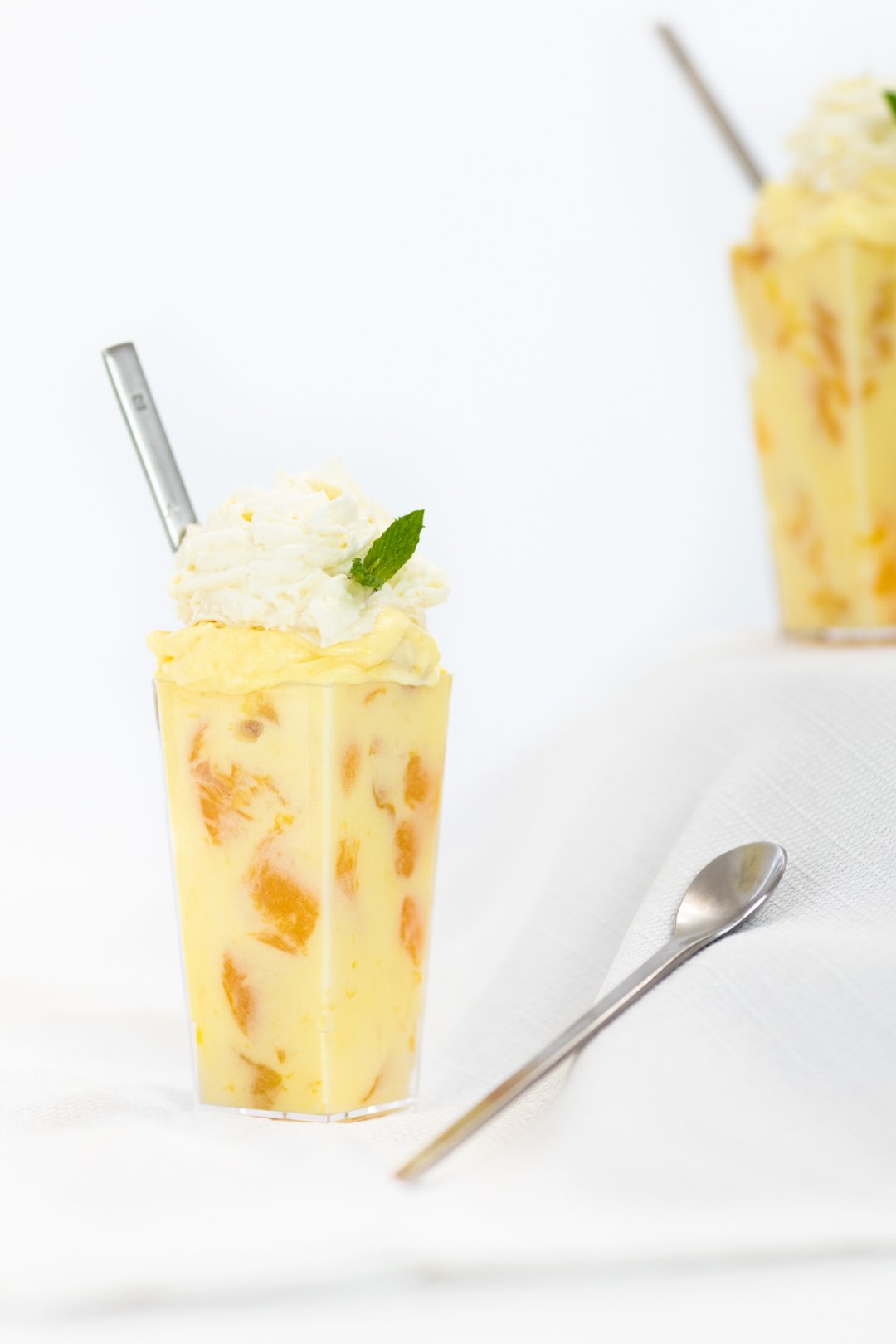 Peach pudding parfaits with a dash of mint for garnish