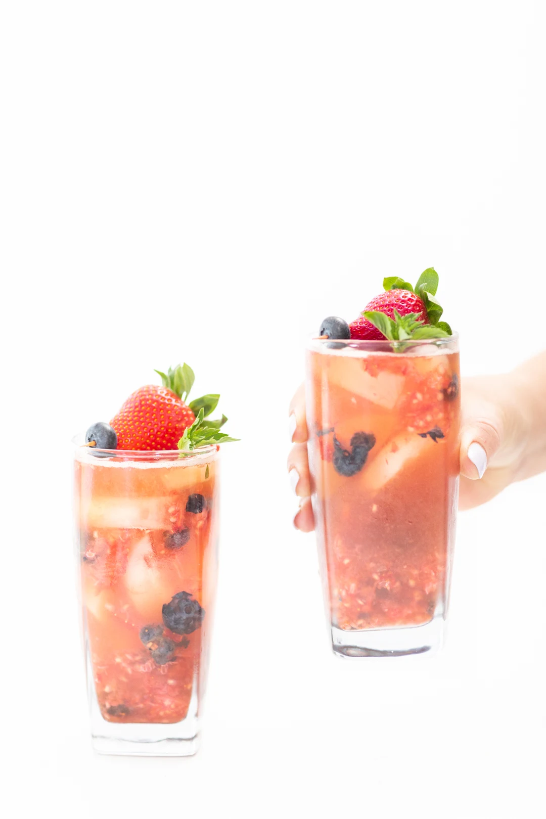 Glasses of fresh iced tea with muddled berries