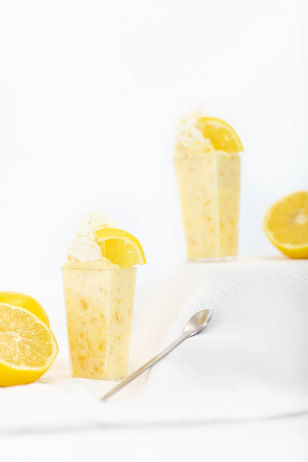 Pretty Pineapple Lemon Parfaits topped with lemon wedges.