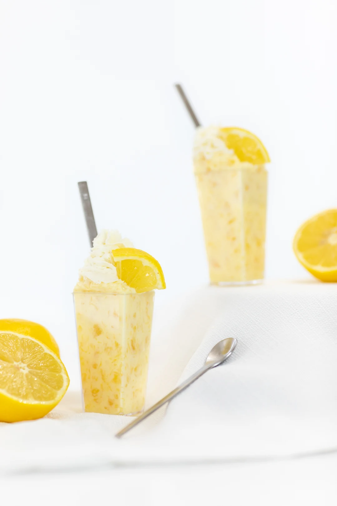 Delish Lemon and Pineapple Dessert Parfait topped with Fresh Lemon Wedges
