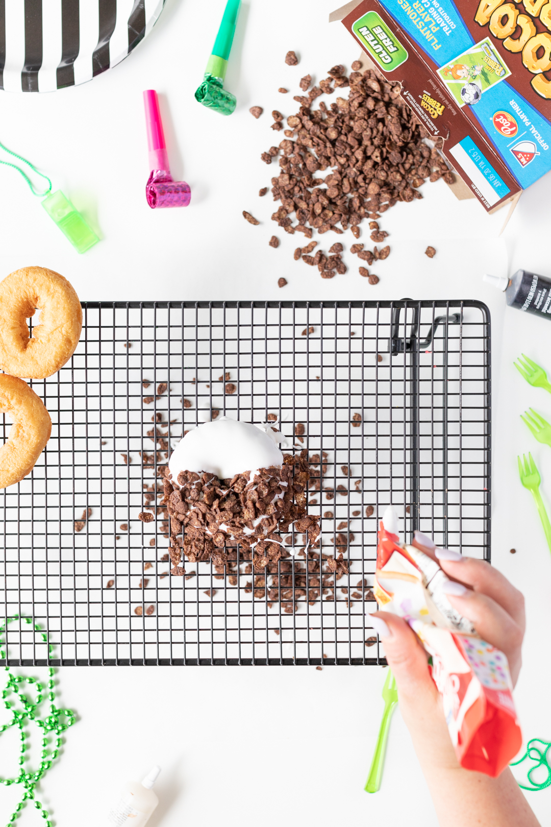 Cocoa Pebbles Donut DIY. Adding Icing.