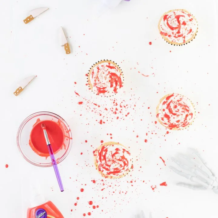 Making Blood Spatter Cupcakes with Red Icing and a food-safe brush.