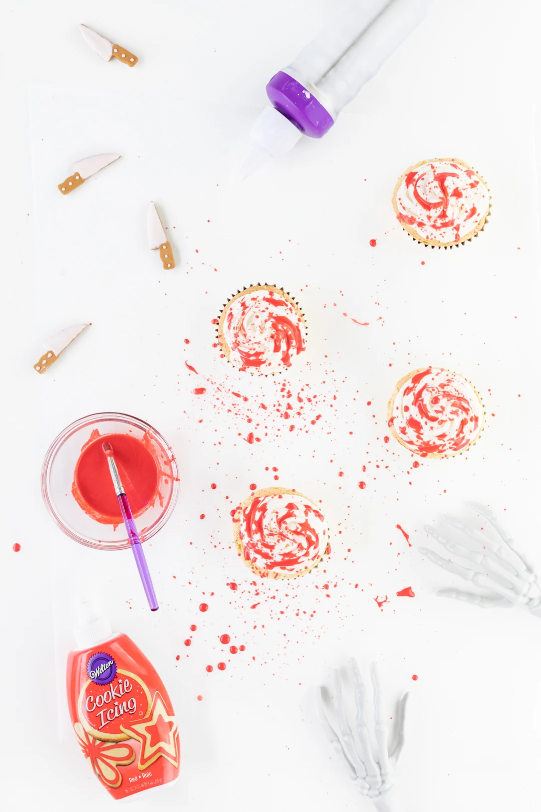 Making Blood Spatter Cupcakes with Red Icing and a food-safe brush.