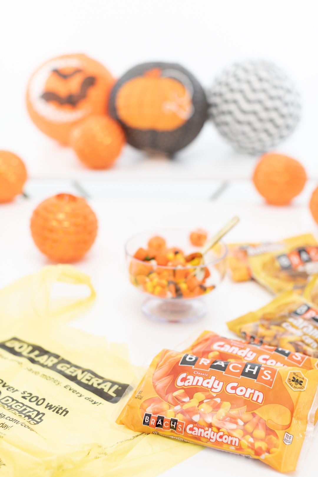 Setting up a party table with Halloween candy and decorations.