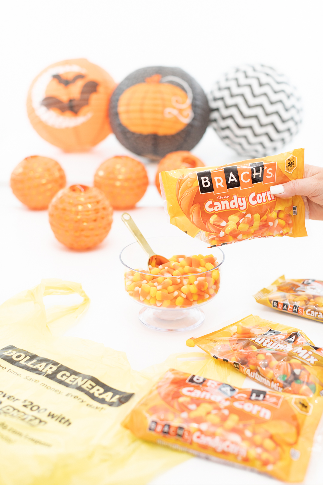 Pouring candy into a candy dish to prepare for a Halloween party.