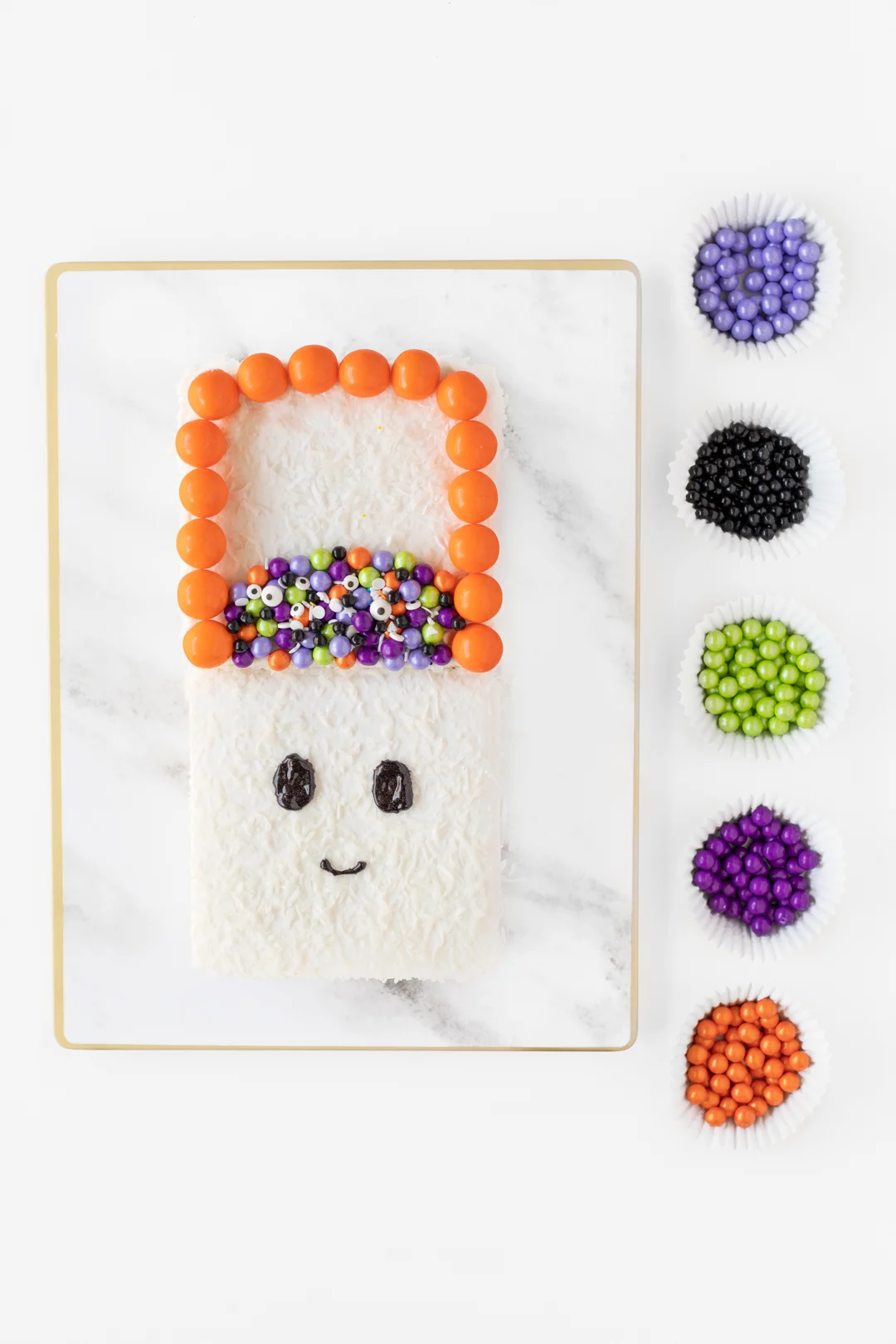 decorating a ghost cake with candies