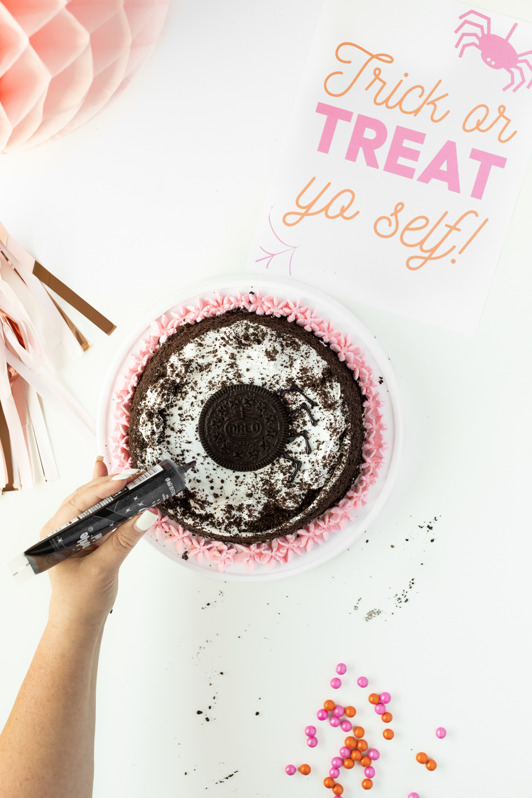 Adding icing to ice cream cake.