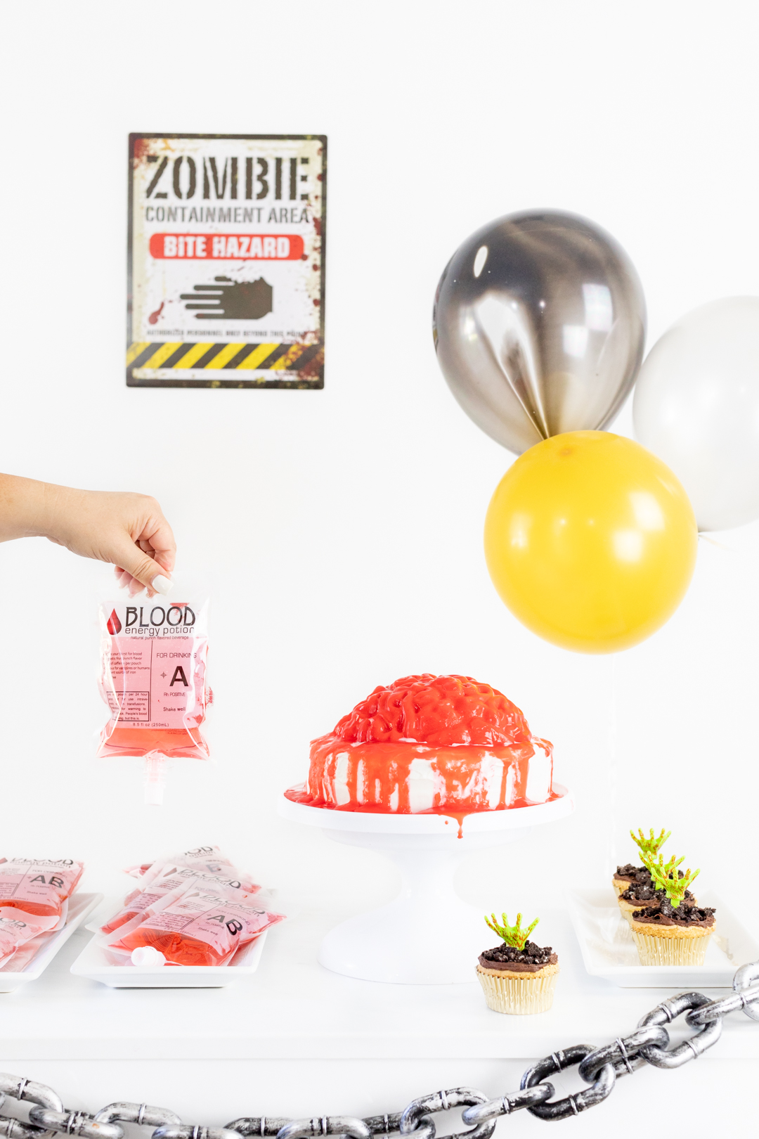 Fun Zombie Party Table with Zombie Sign, Bloody Brain Cake, Zombie Cupcakes.