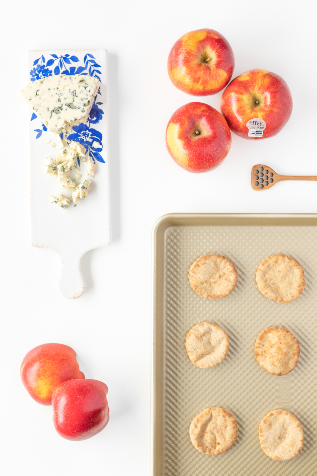 mini pizza appetizers being prepared with fresh apples and gorgonzola cheese