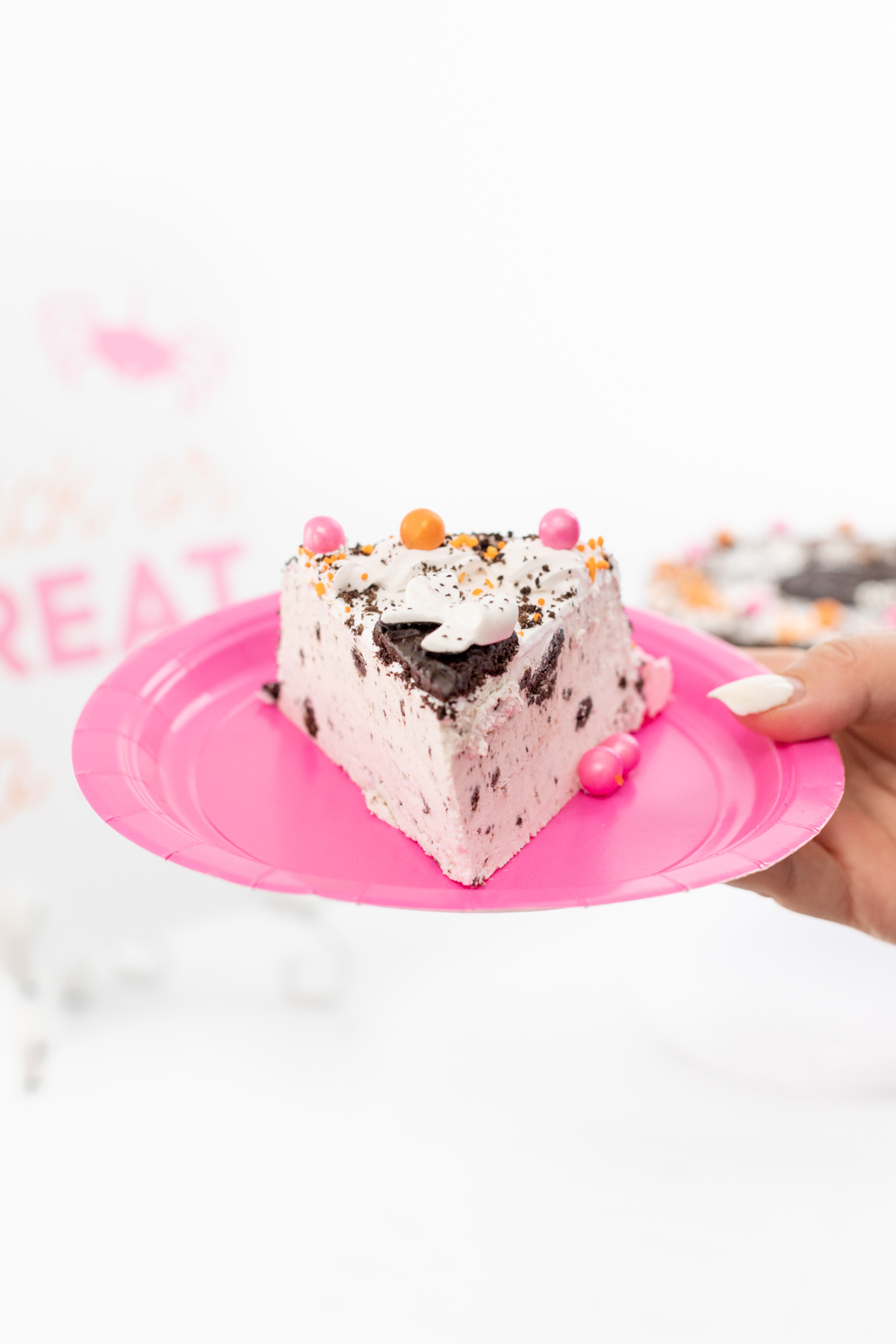 Slice of pretty pink OREO ice cream cake.