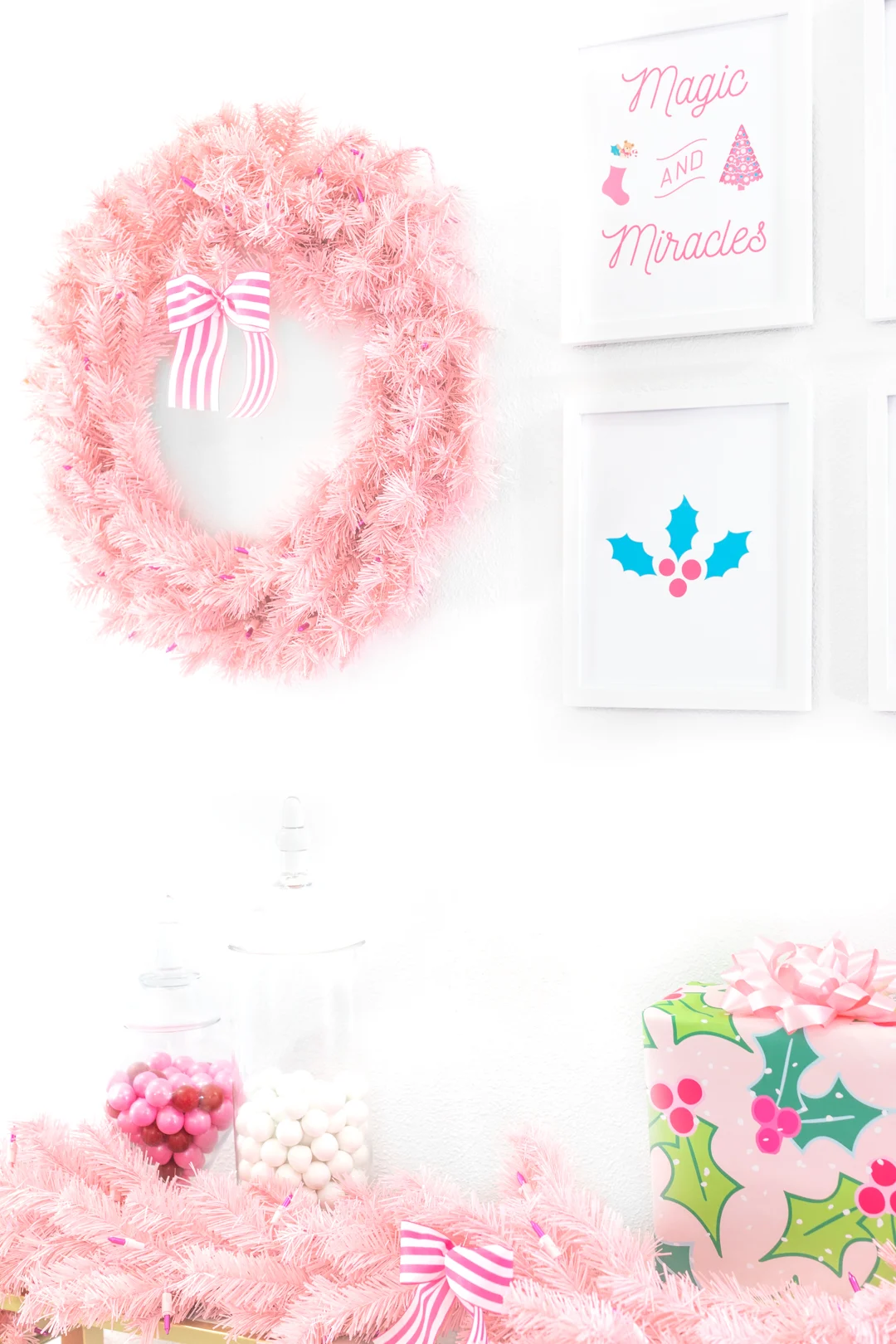 pretty pink christmas display with wreath and wall art