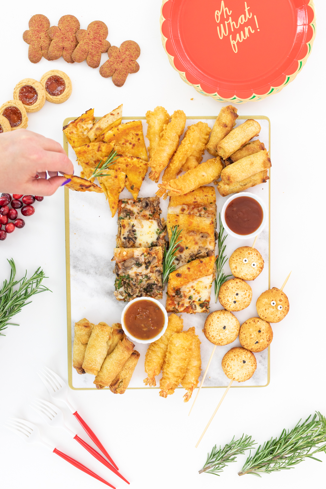 setting up an appetizer board with flatbread, eggrolls and shrimp