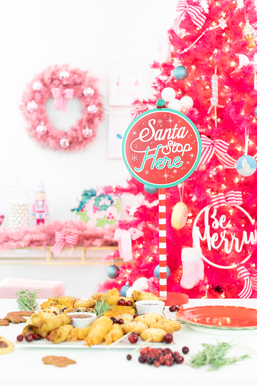 Santa Stop Here Sign from Target with food spread and pink holiday decorations