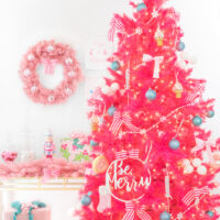 bright pink christmas tree with dessert decorations like candy land