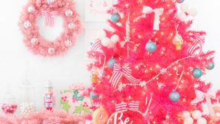 bright pink christmas tree with dessert decorations like candy land