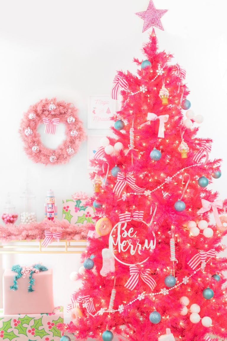 bright pink christmas tree with dessert decorations like candy land