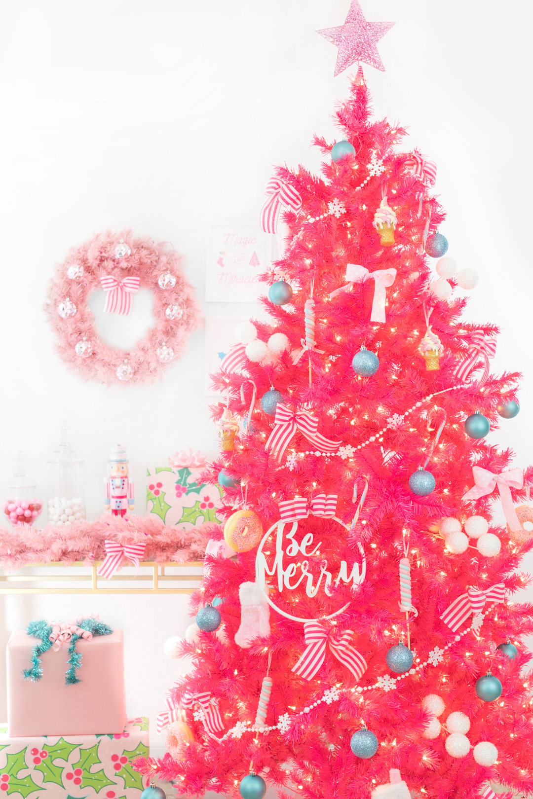 bright pink christmas tree with dessert decorations like candy land