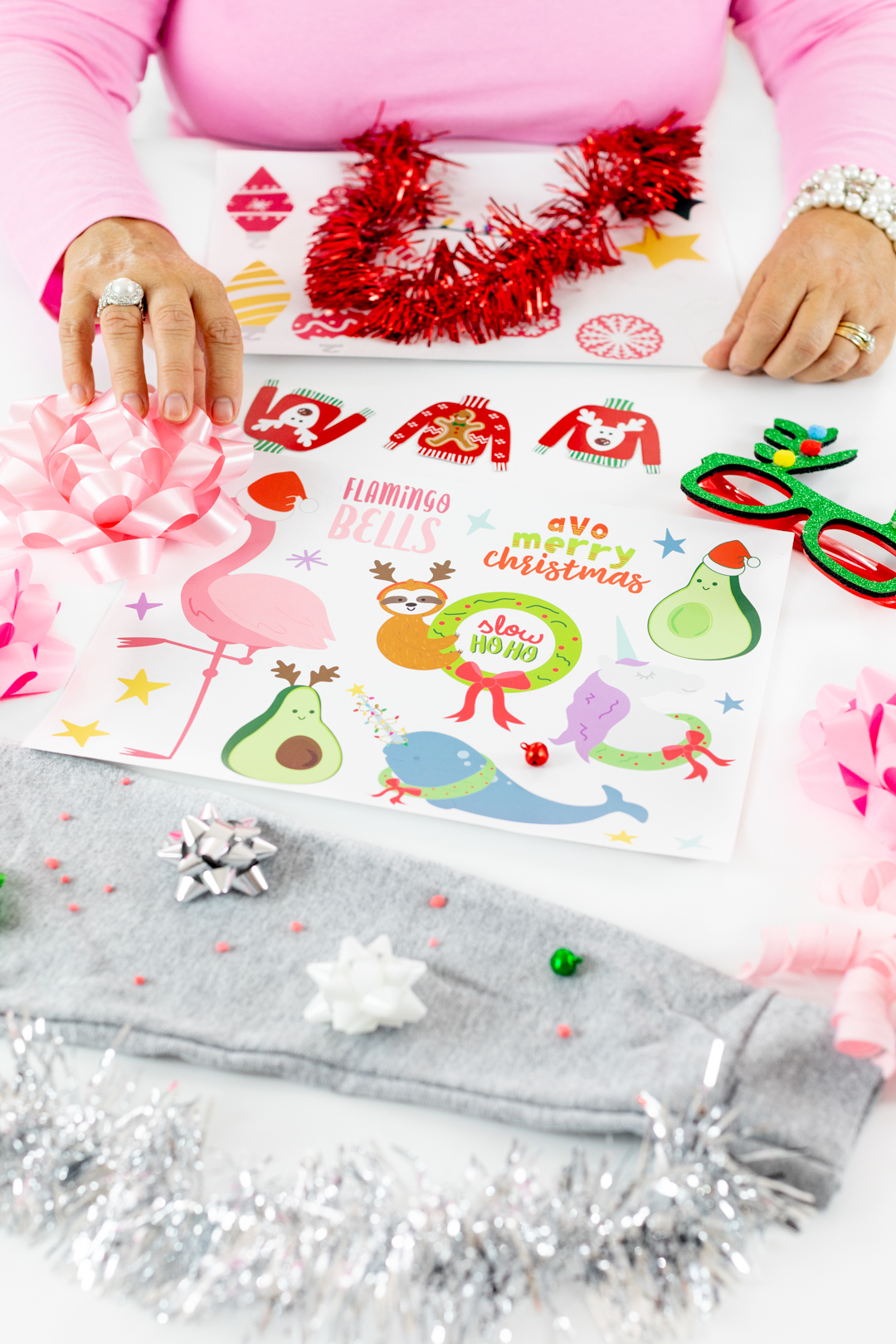 Ugly Sweater DIY Table with stickers, bowls, bells and silly holiday themed glasses.