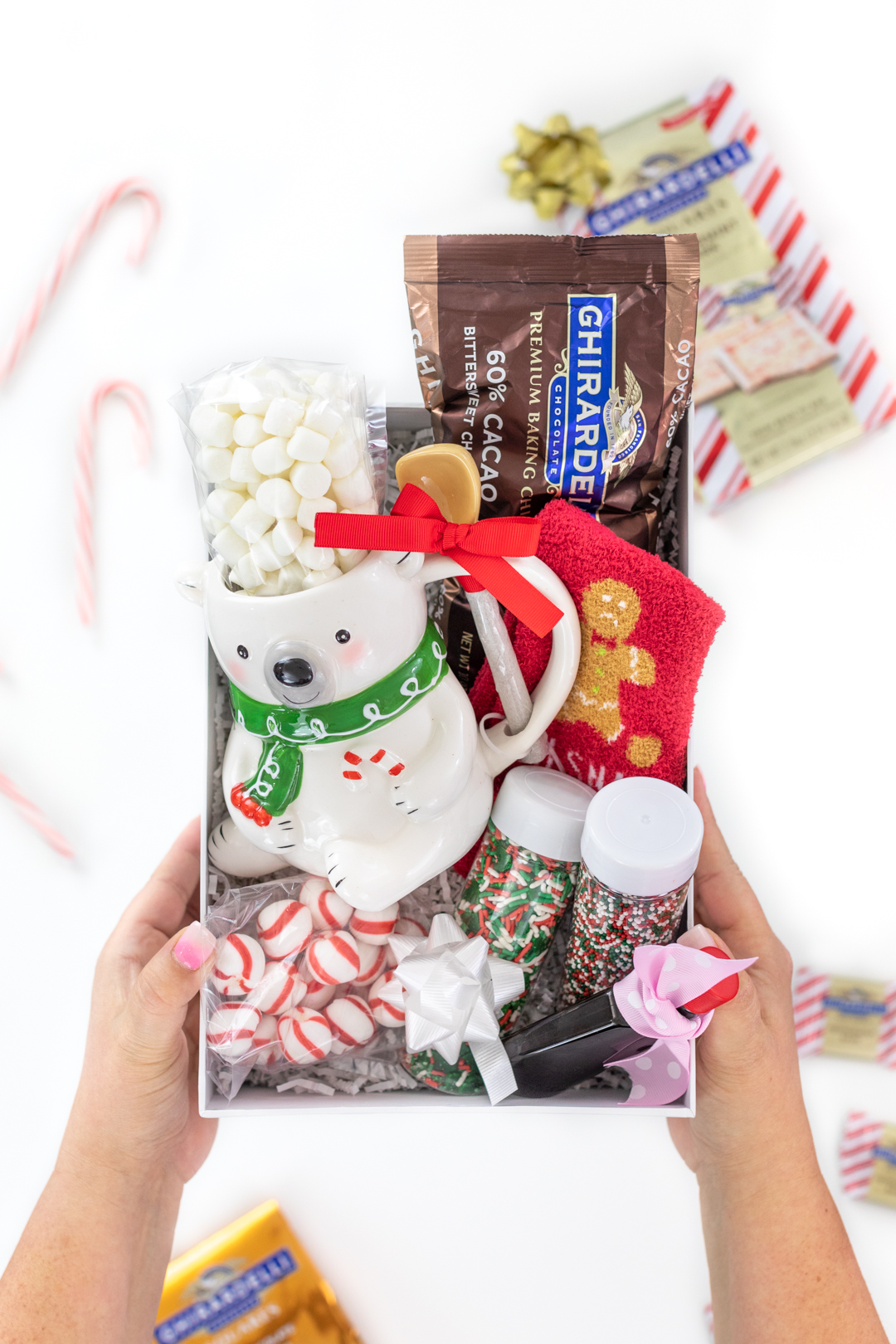 diy hot chocolate gift box with chocolate chips, mini marshmallows, sprinkles, vanilla and a cute polar bear mug