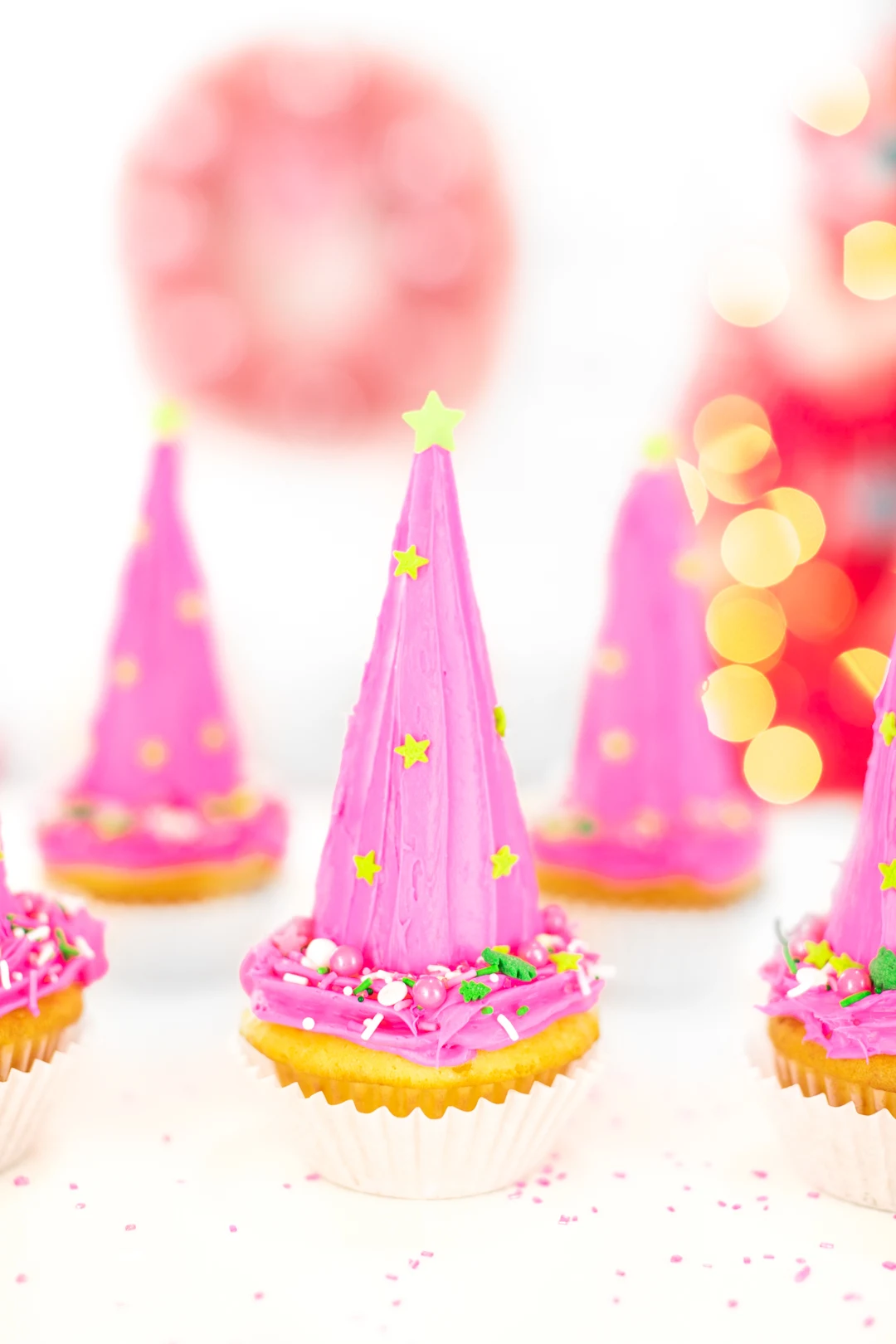 pretty christmas tree cupcakes with pink frosting and green touches