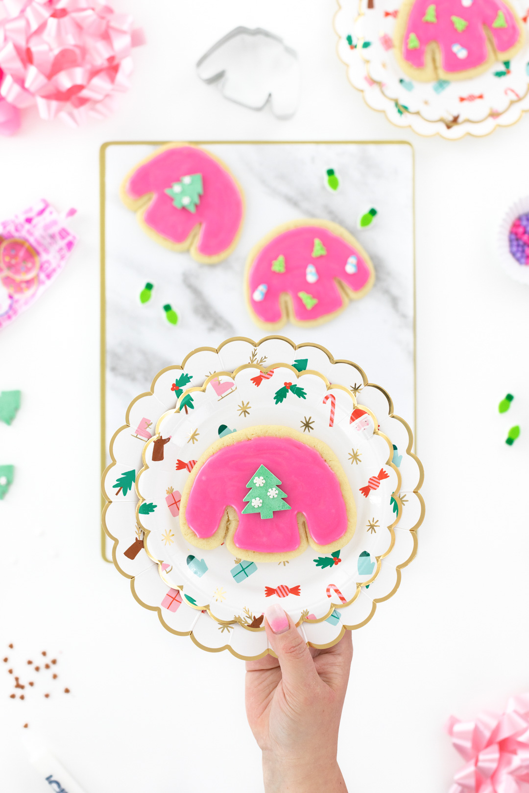 pink ugly sweater cookie on a plate