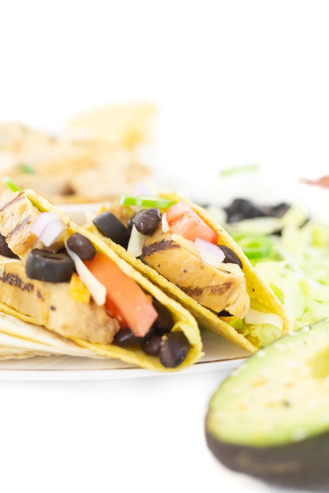 chicken tacos up close with tomatoes and black beans