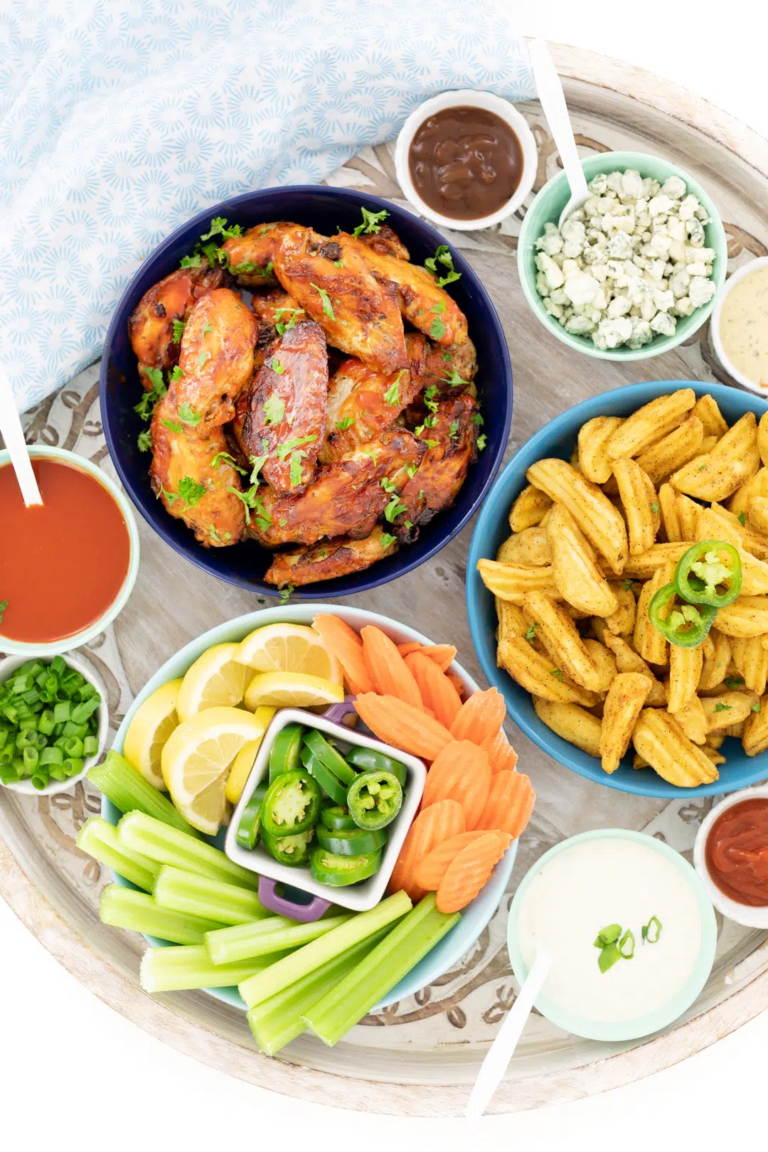 chicken wing buffet with blue cheese, celery, carrots, green onions and selection of dips