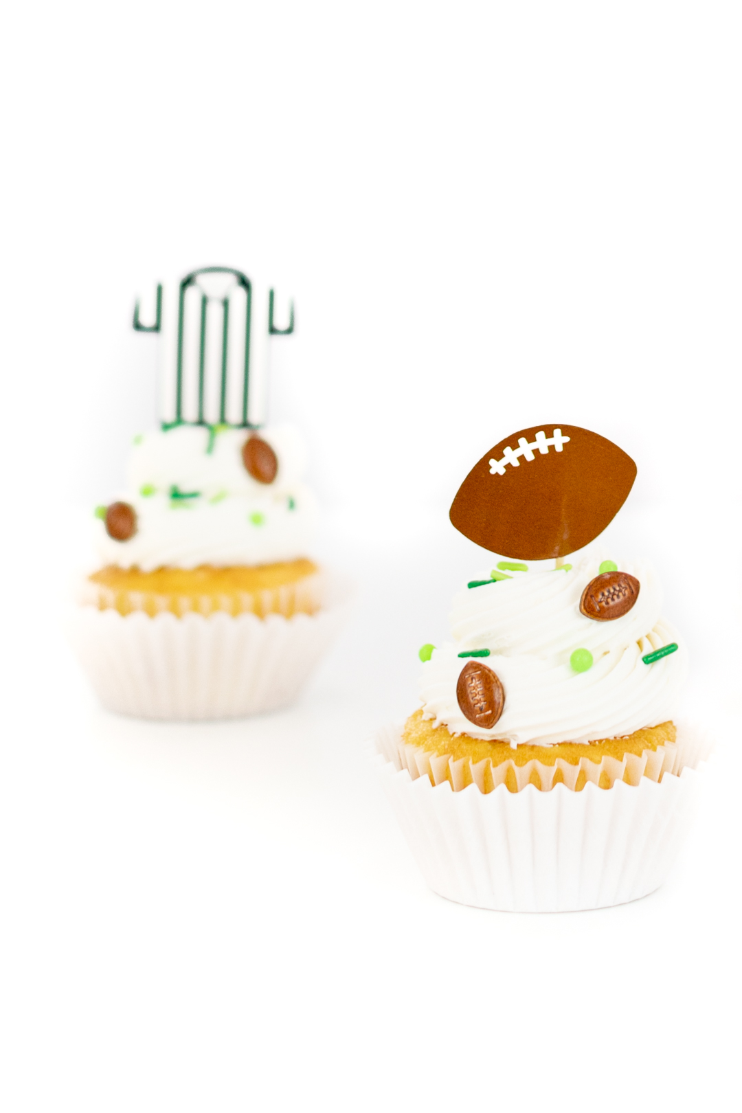 football cupcakes with sprinkles and themed cupcake toppers