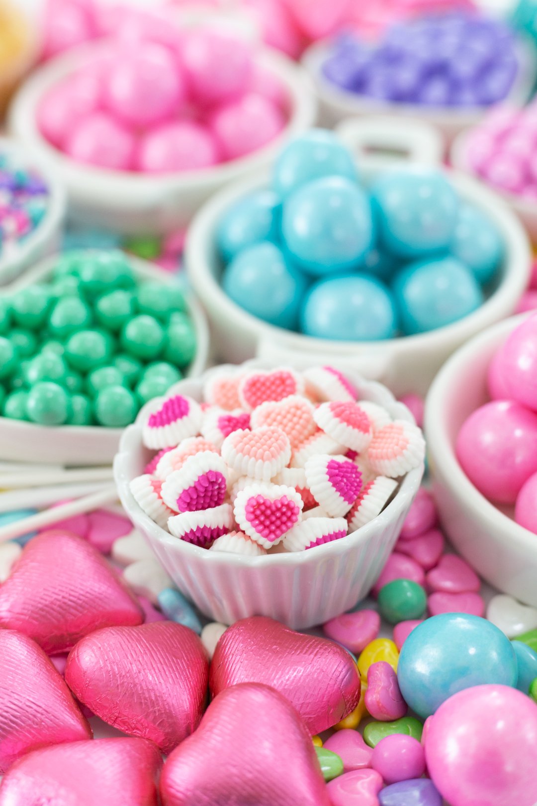 dish filled with pastel valentine's day candies and icing decorations