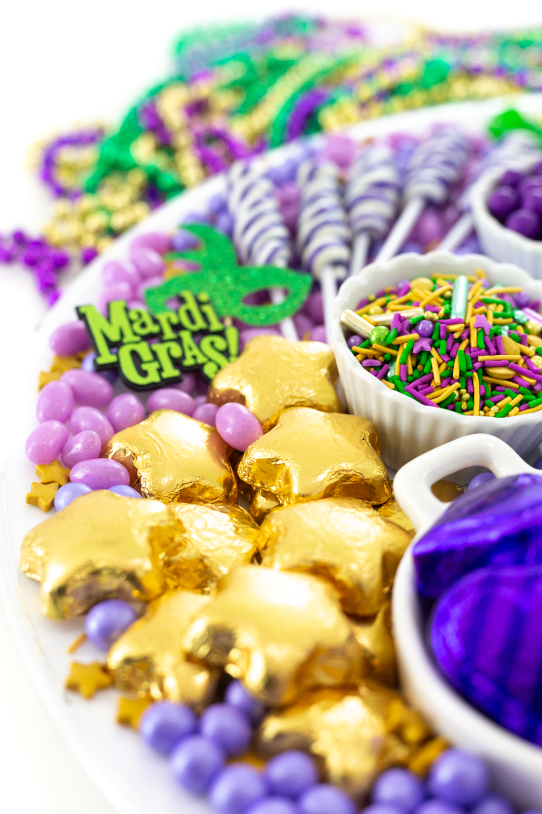 gorgeous tray of mardi gras themed candies. Pretty gold star chocolates and king cake inspired sprinkles from Fancy Sprinkles.