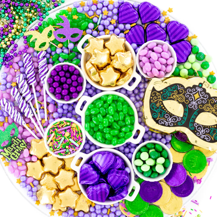 mardi gras candy charcuterie board made with green, purple and gold candies.