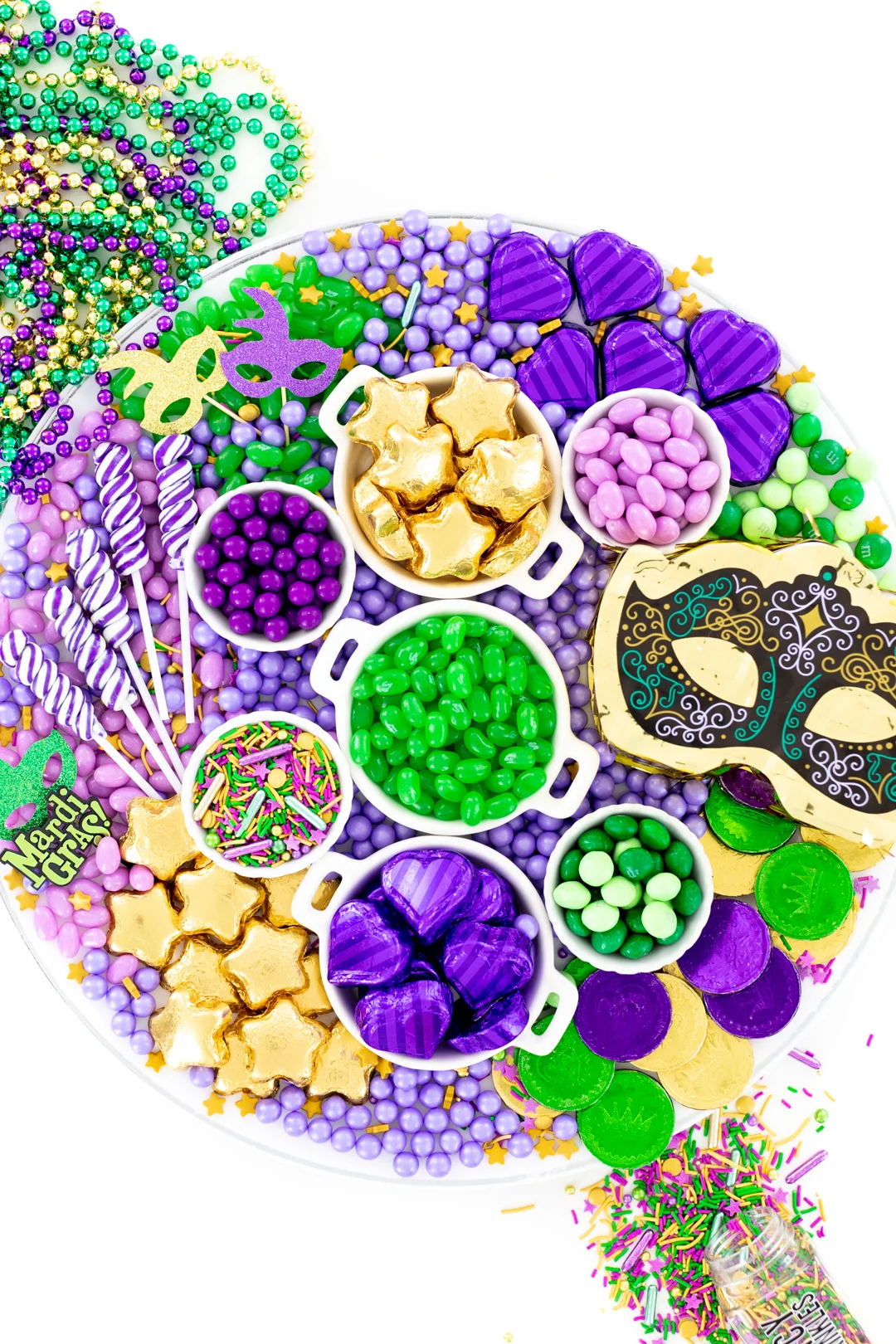mardi gras candy charcuterie board made with green, purple and gold candies.