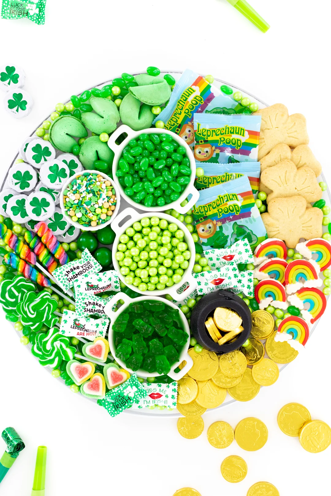 St. Patrick's Day candy board with green, rainbow and gold candies.