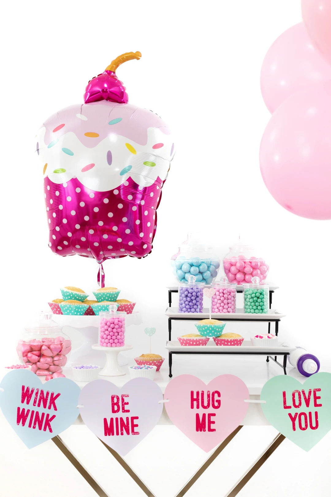 cupcake party spread with giant cupcake shaped balloon