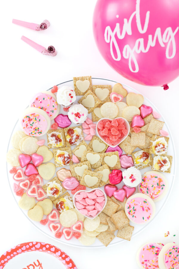 pretty charcuterie board with desserts and cheese and crackers