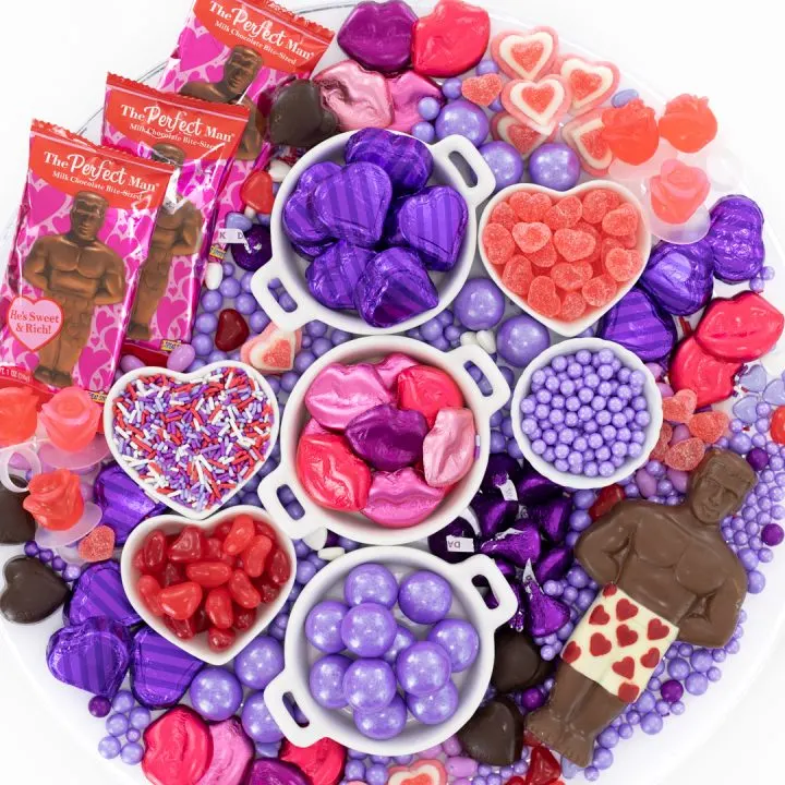 Galentine's Day Themed Candy Charcuterie Board loaded with red and purple candies.