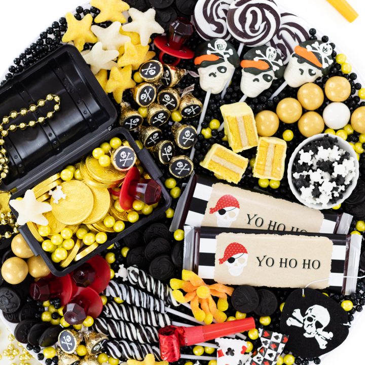 pirate party dessert idea with starfish gummy candy, skull candy, black licorice pirate coins