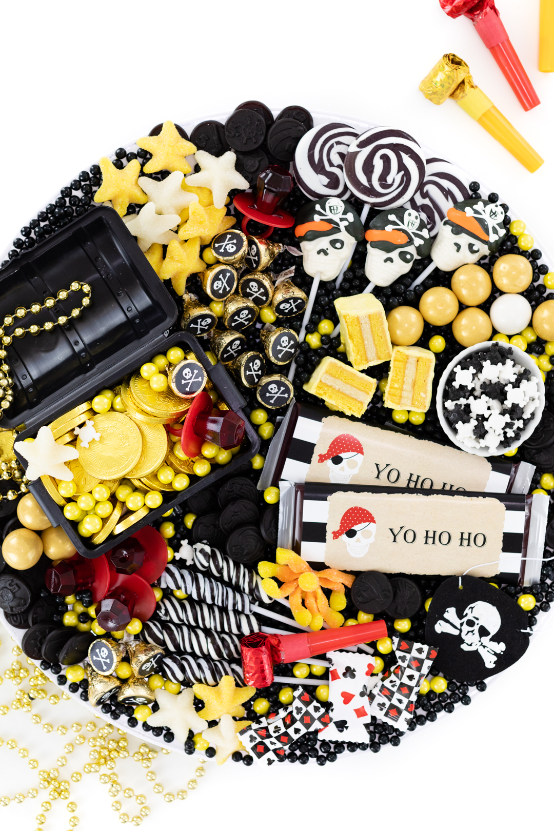 pirate party dessert idea with starfish gummy candy, skull candy, black licorice pirate coins