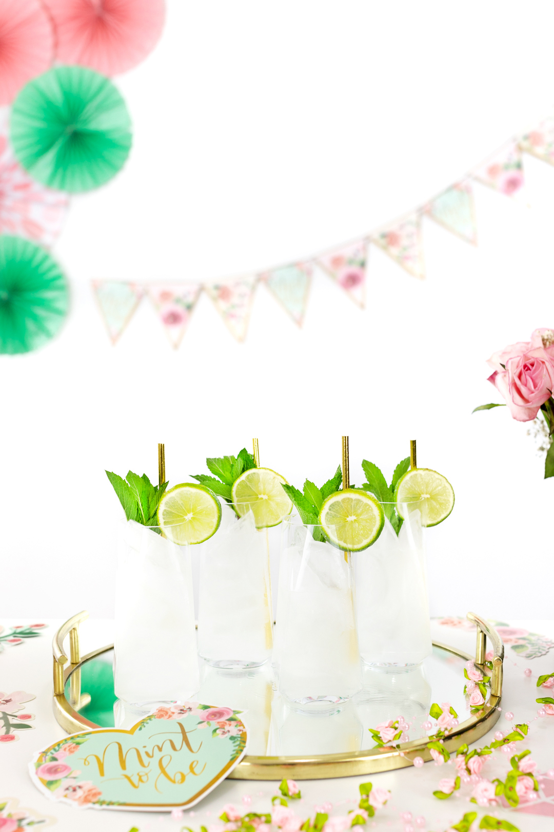 tray of mojitos with fresh mint and lime slices