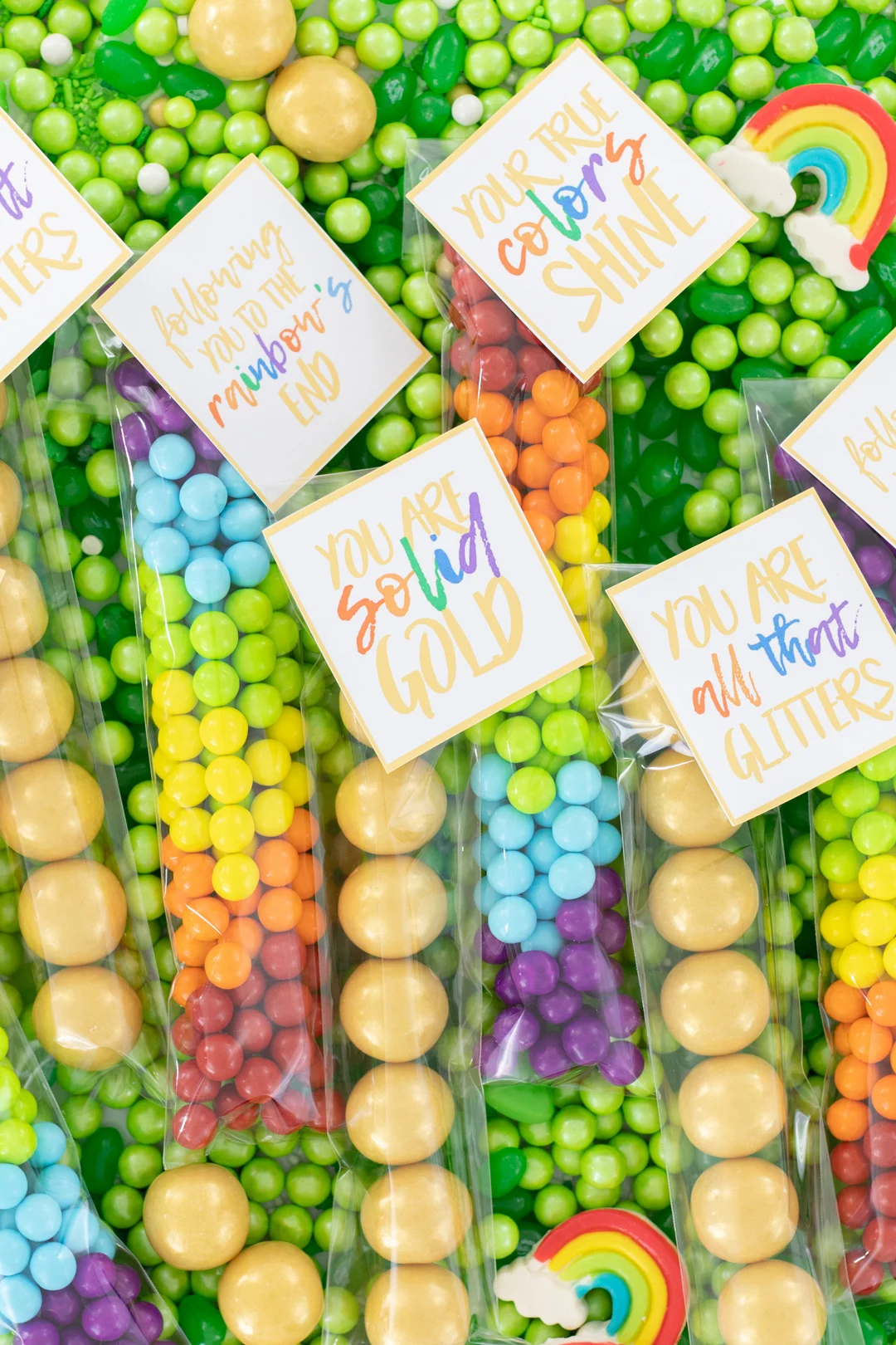 treat bags for st. patrick's day with gold gumballs and rainbow sixlets