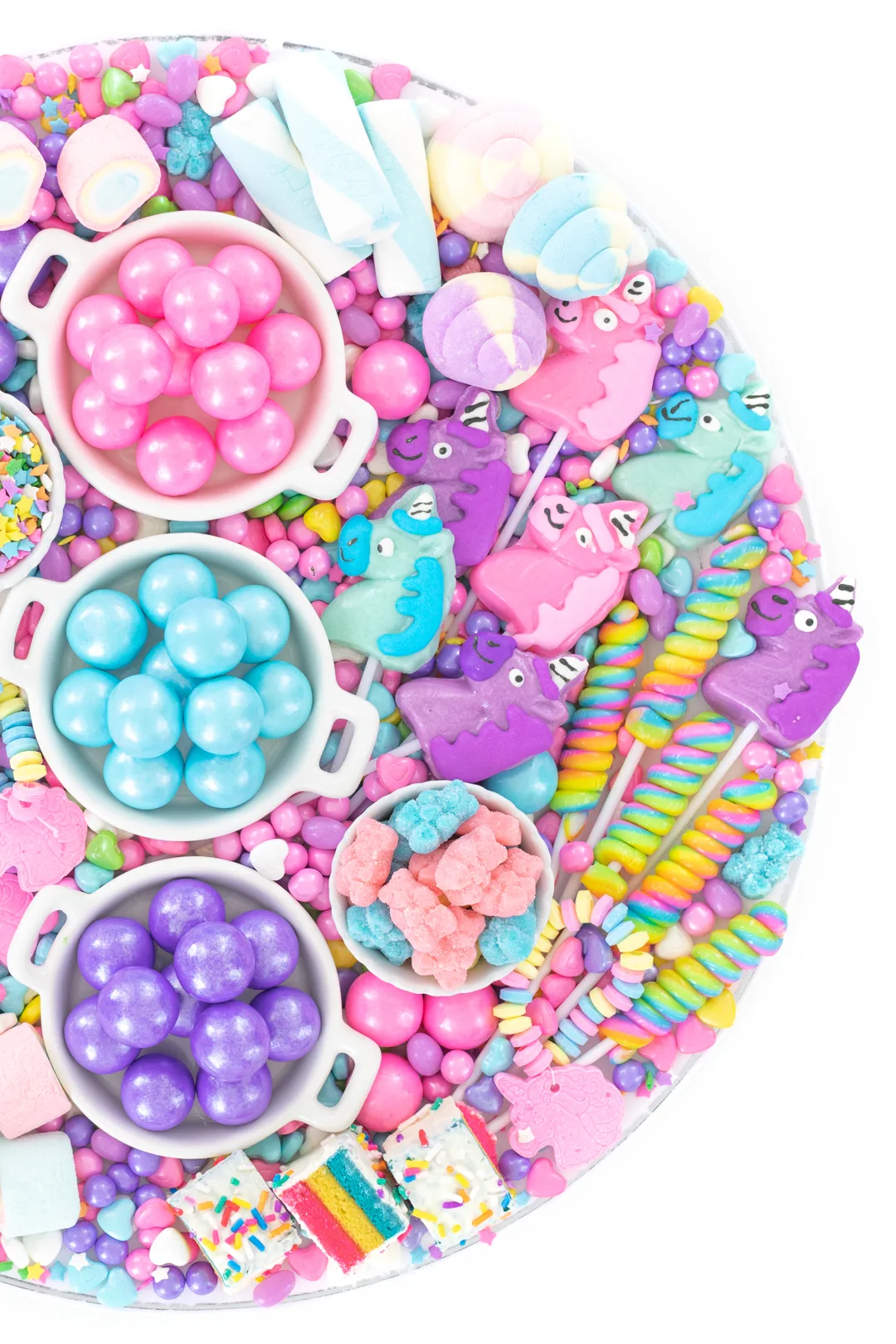 tray of pastel pink, blue and purple candy and gumballs